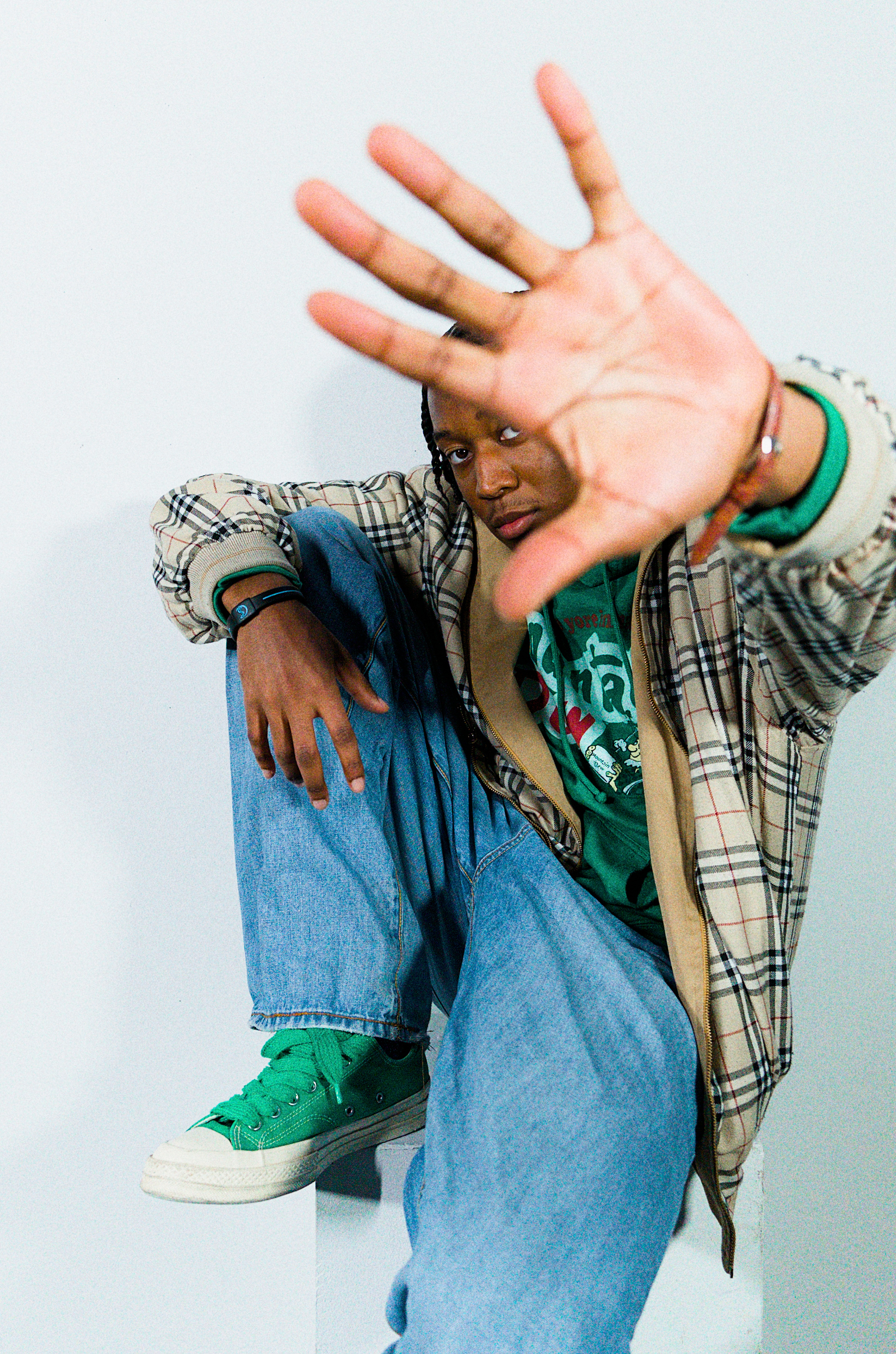 A member of the Thursday community reaching toward the camera in a thrifted fit